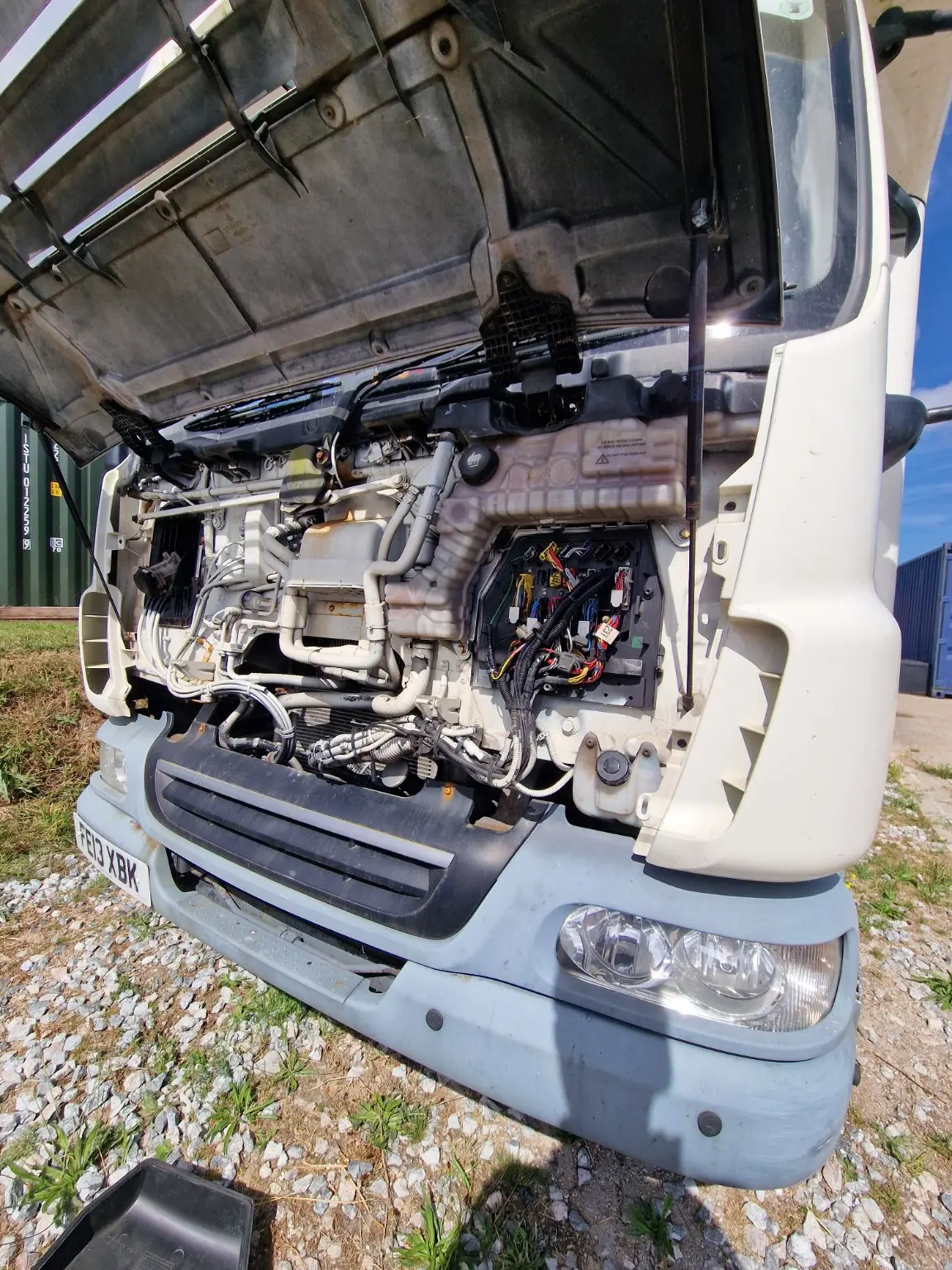Open-cab commercial vehicle undergoing electrical diagnosis
